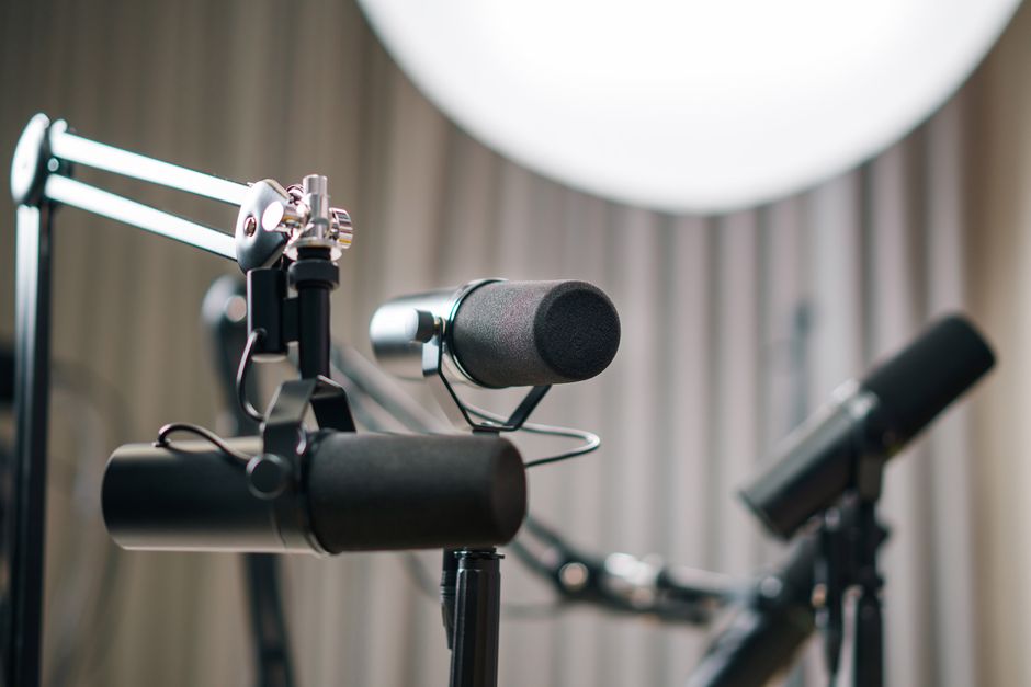 Close-up of dynamic microphones in a professional studio setting, ideal for podcasts and broadcasts.